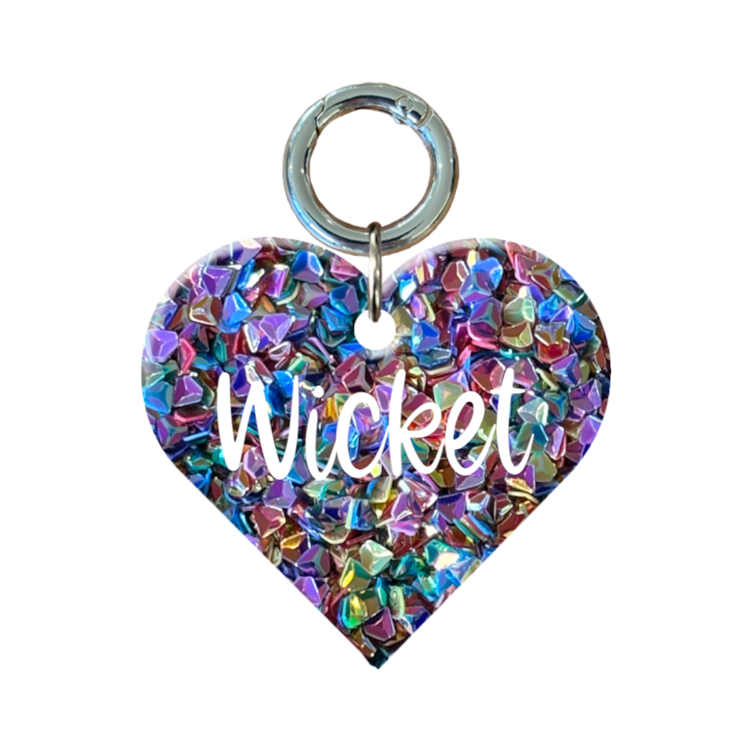 Heart-shaped glitter dog tag with colorful gems and the name Wicket in white text