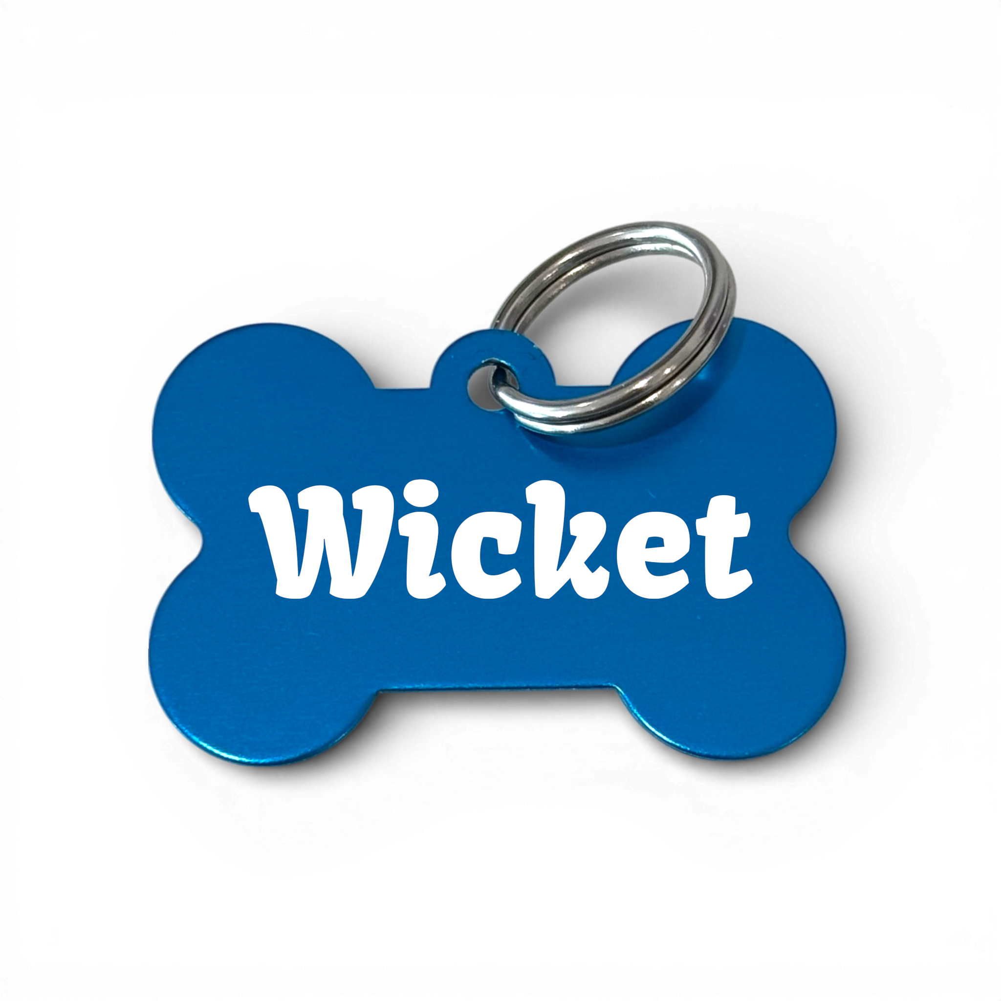 Blue bone-shaped dog tag with the name Wicket and silver keyring, personalised pet ID accessory