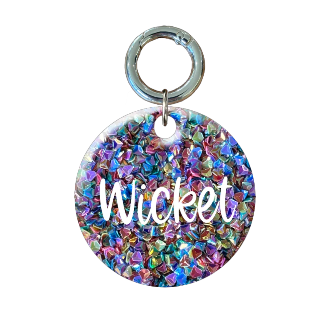 Personalised round glitter dog tag with name and phone number.