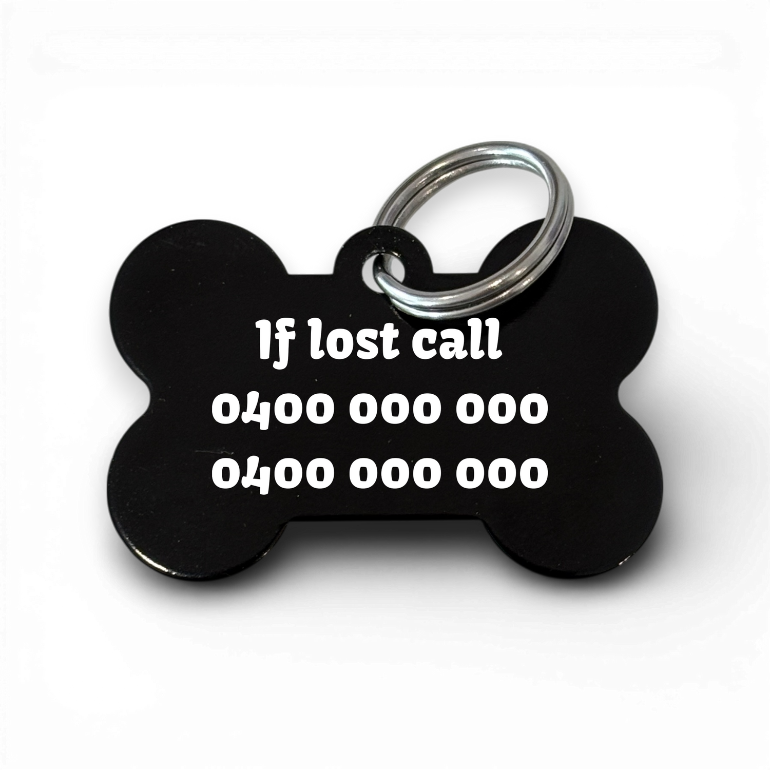 Black bone-shaped aluminium dog tag with dogs name  and phone number engraved.