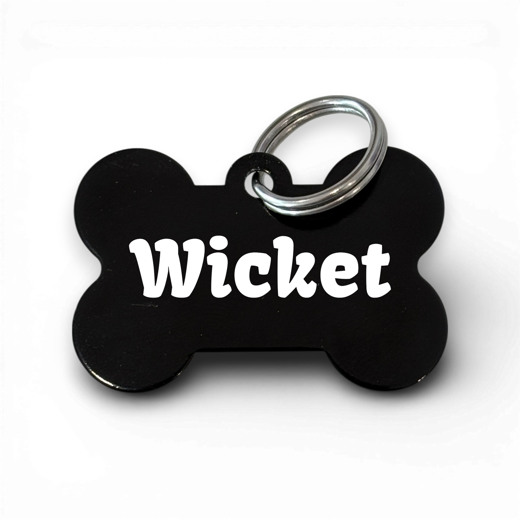 Black bone-shaped aluminium dog tag with dogs name  and phone number engraved.