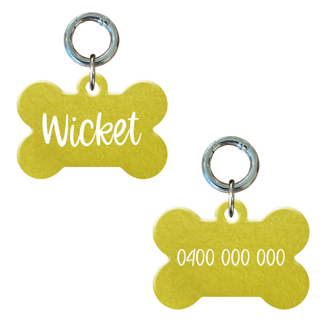 Yellow bone-shaped personalised dog tag with pet name and phone number engraving