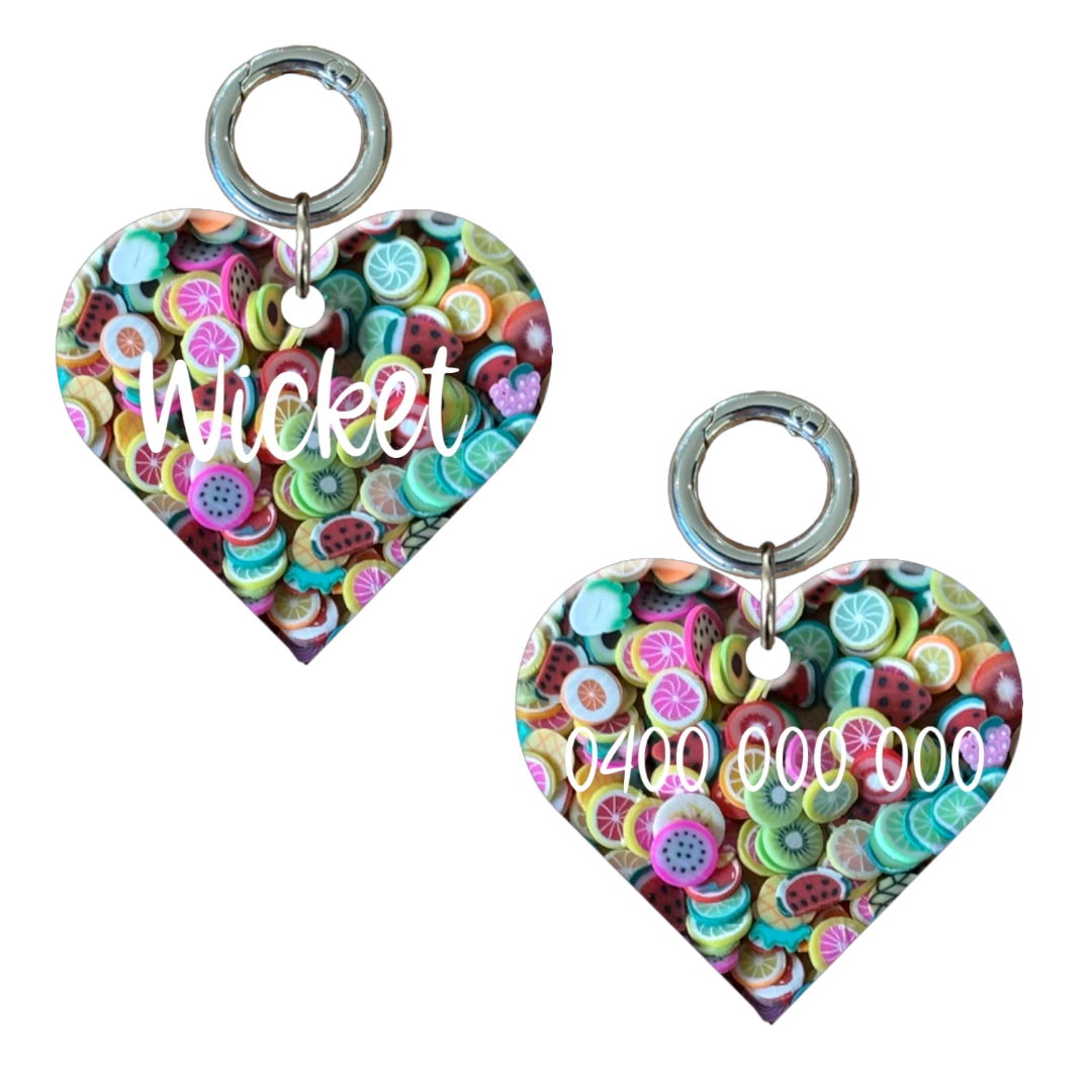 Heart-shaped dog tag with colorful fruit pattern, personalized name and phone number.