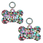 Colorful fruit-themed bone-shaped personalized dog tag with metal ring and engraved contact info.