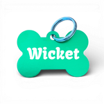 Green bone-shaped aluminium dog tag with dogs name  and phone number engraved.