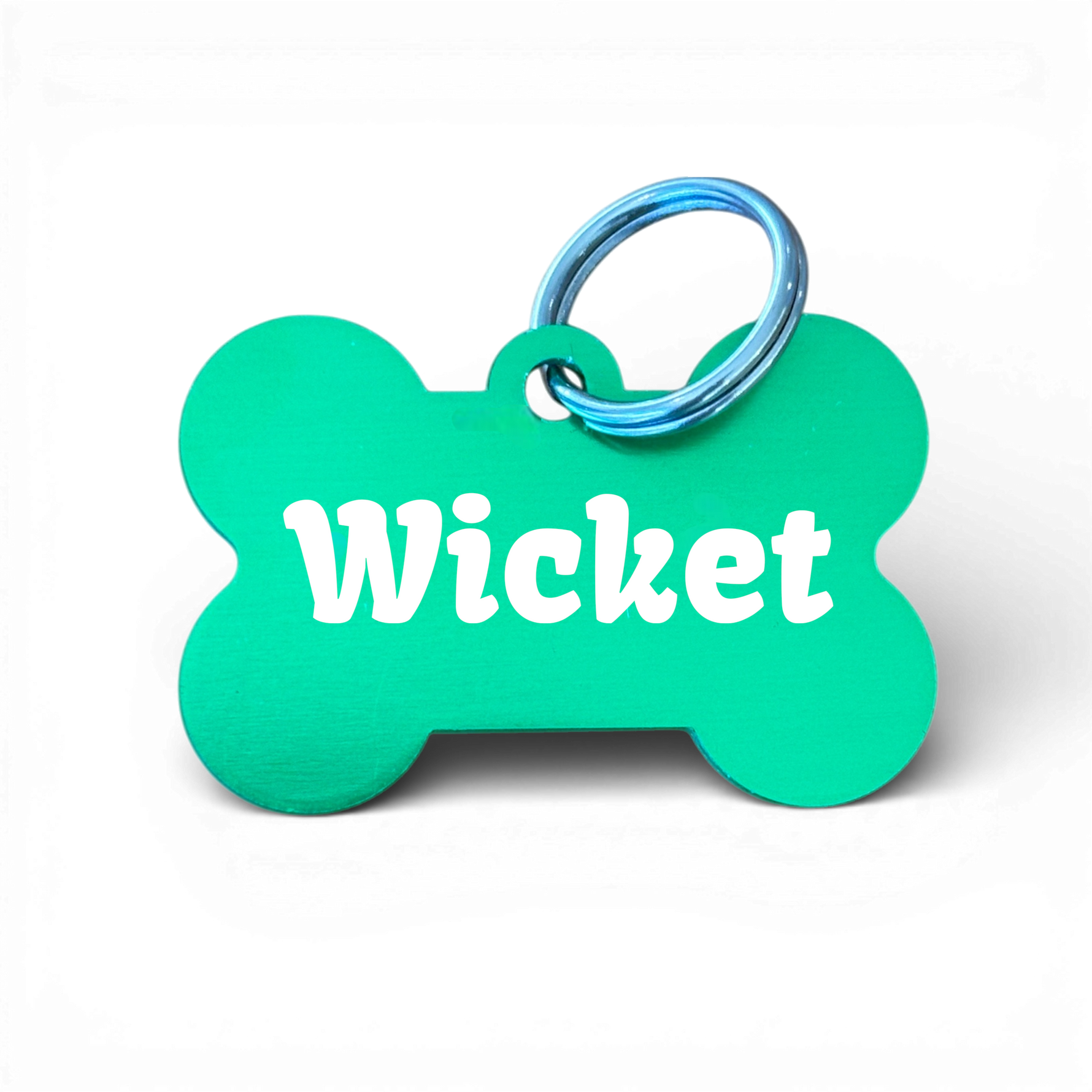 Green bone-shaped aluminium dog tag with dogs name  and phone number engraved.