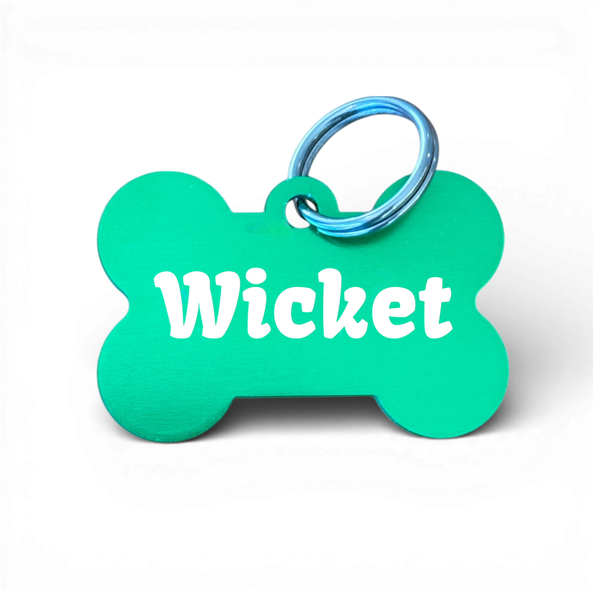 Green bone-shaped aluminium dog tag with dogs name  and phone number engraved.