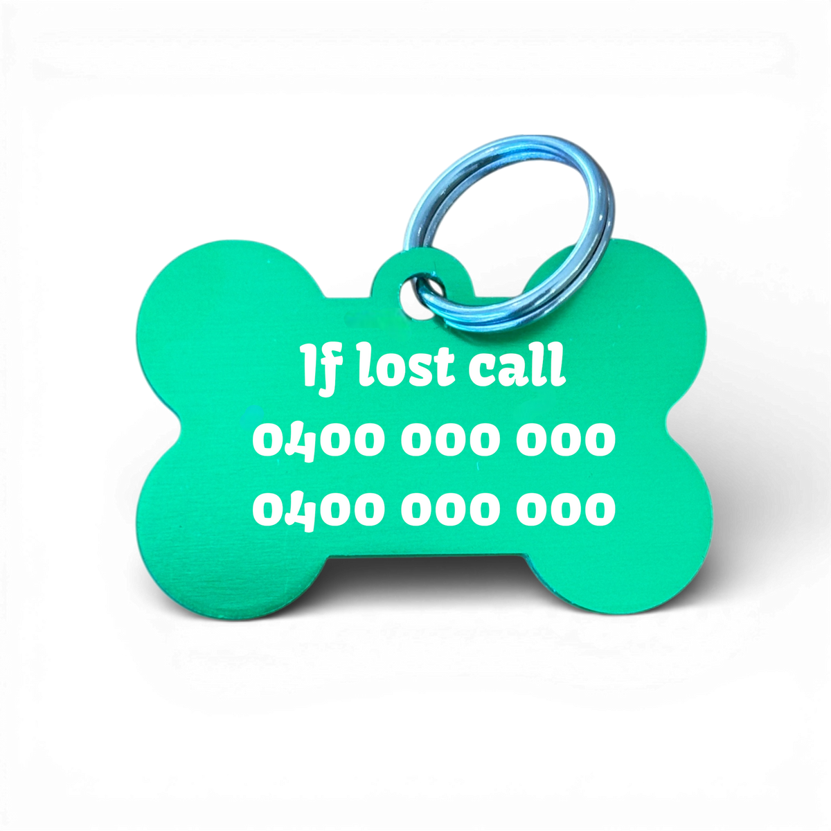 Green bone-shaped aluminium dog tag with dogs name  and phone number engraved.
