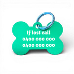 Green bone-shaped aluminium dog tag with dogs name  and phone number engraved.