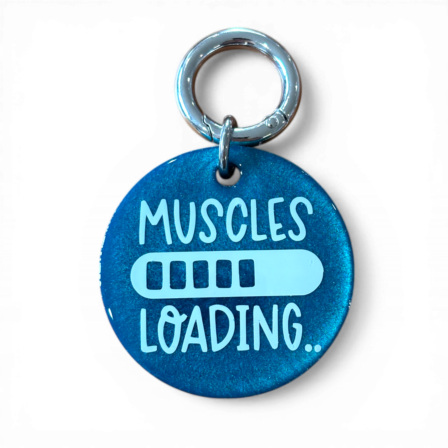 Blue pet tag with 'MUSCLES LOADING' text on a white background