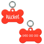 Glow in the dark bone-shaped personalised dog tag with name and phone number in white.