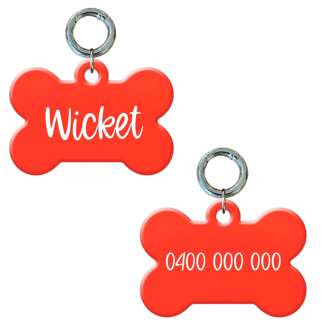 Glow in the dark bone-shaped personalised dog tag with name and phone number in white.