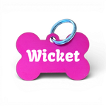 Pink bone-shaped aluminium dog tag with dogs name  and phone number engraved.