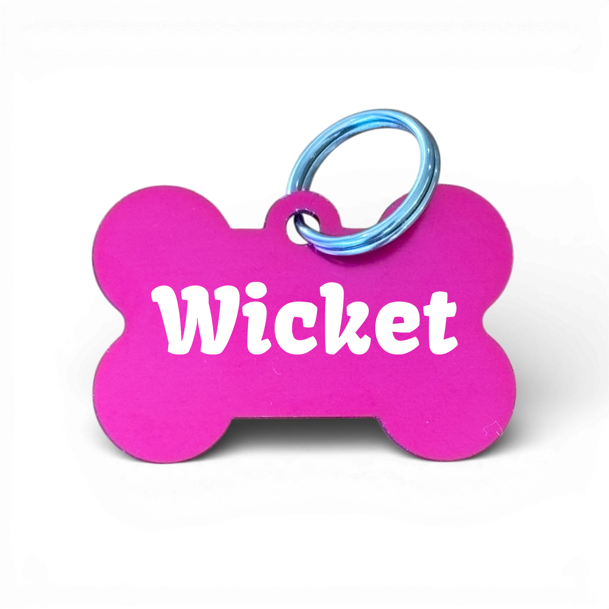 Pink bone-shaped aluminium dog tag with dogs name  and phone number engraved.