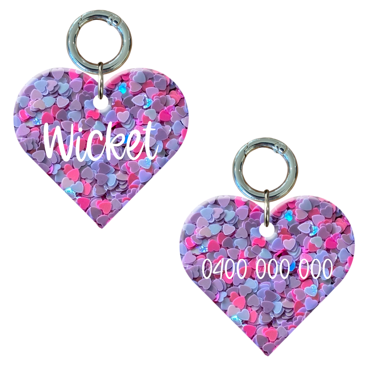 Personalised heart-shaped dog tag with pink and purple hearts and engraved name and number.