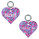 Personalised heart-shaped dog tag with pink and purple hearts and engraved name and number.
