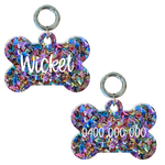 Colorful bone-shaped personalised dog tag with glitter, engraved with name and phone number.