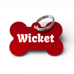 Red bone-shaped aluminium dog tag with 'Wicket' engraved, metal key ring attached