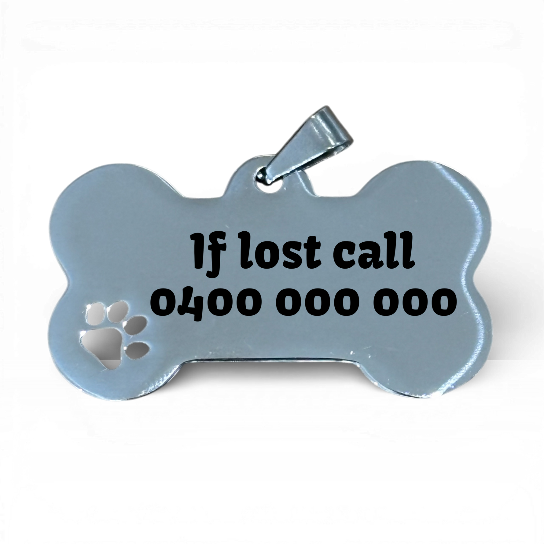Stainless steel bone-shaped dog tag with engraved text and paw cutout on white background.
