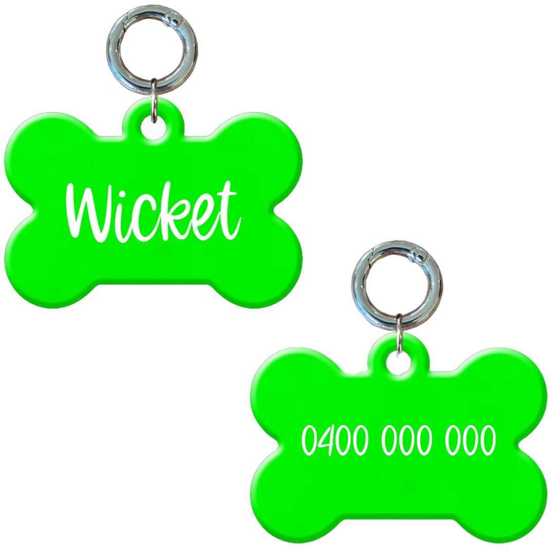 Personalised flourescent green bone-shaped dog tag with name and phone number.