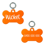 Personalised flourescent orange bone-shaped dog tag with name and phone number.