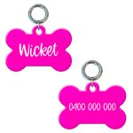 Personalised flourescent pink bone-shaped dog tag with name and phone number.