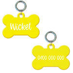 Personalised flourescent yellow bone-shaped dog tag with name and phone number.