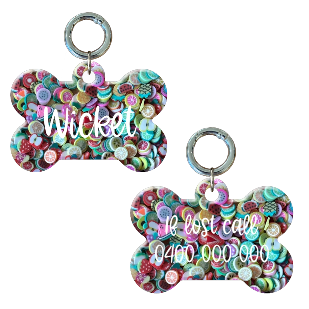 Colorful bone-shaped personalised dog tag with fruit. Customised with name and contact number.